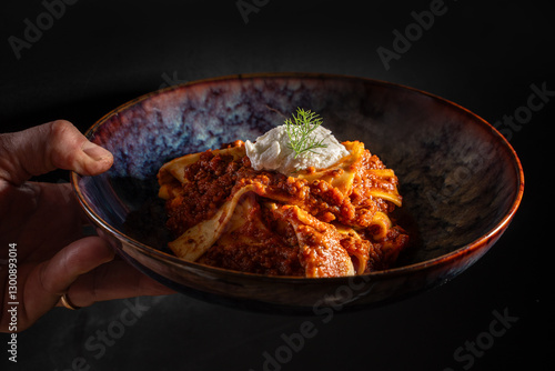 Photos Gourmet Italian pasta with rich meat sauce and ricotta in ceramic bowl