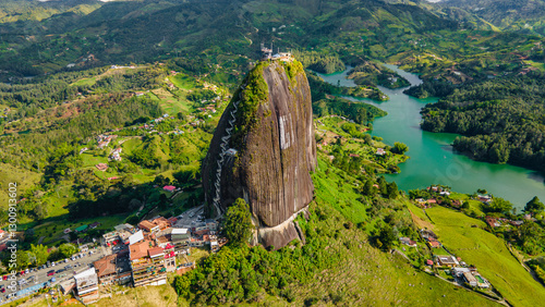 Aerial View of El Peñol Rock in Guatape, Antioquia, Colombia Surrounded by Lush Green Landscape and Lake