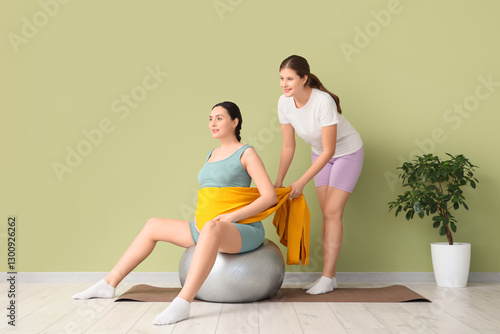 Pregnant woman exercising o...