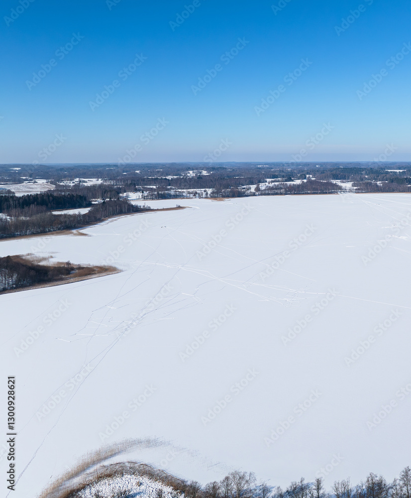 Obraz premium Winter landscape with country road near Sivers lake. Latvia, Latgale.