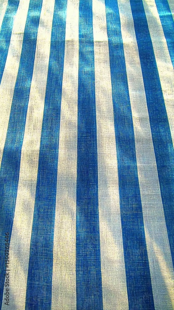 Fototapeta premium Blue and White Stripes: A vibrant textile pattern of bold blue and white stripes creates a modern and eye-catching surface.