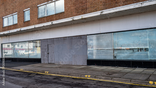 Closed and empty shops in a shopping centre depicting the dying UK high street.