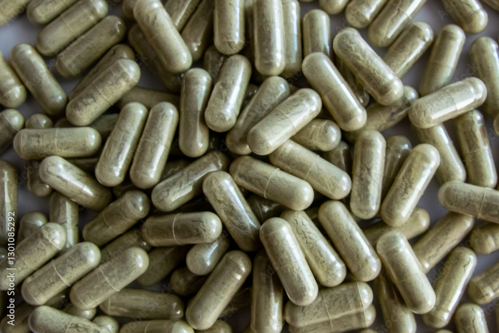Green tablets or pills on the black stone background. Green tablets or pills on the black stone background.