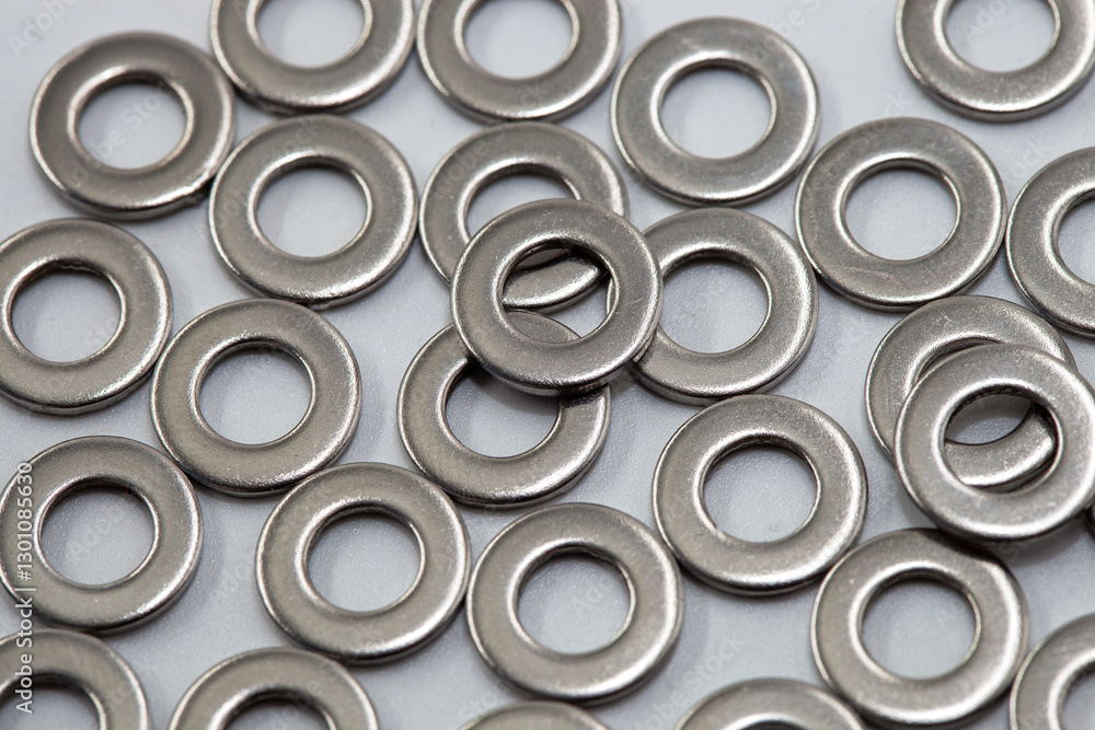 Heap of stainless shims. Background. PIle of shiny screw washers. PIle of shiny screw washers. Steel washers for screws used in carpentry and handicrafts for industrial and household. Heap of stainless shims. Background. PIle of shiny screw washers. PIle of shiny screw washers. Steel washers for screws used in carpentry and handicrafts for industrial and household.