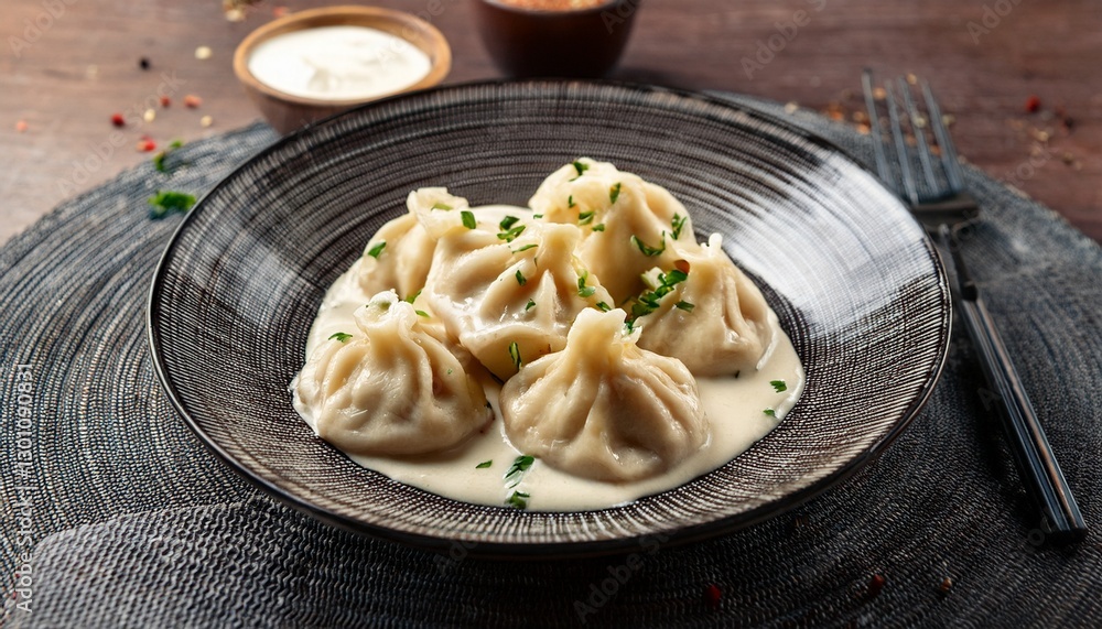dumplings served in creamy sauce create a visually appealing culinary experience on a textured plate