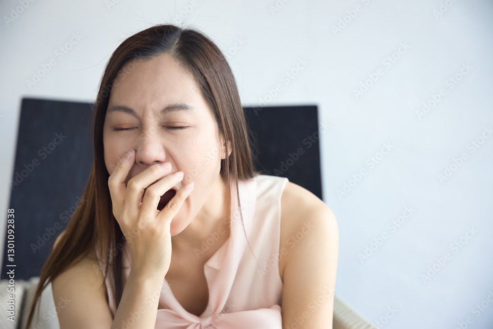 Tired and sleepy middle aged asian woman yawning from overwork, stress, insomnia, brain fog, vitamin or nutrition deficiency concept image Tired and sleepy middle aged asian woman yawning from overwork, stress, insomnia, brain fog, vitamin or nutrition deficiency concept image