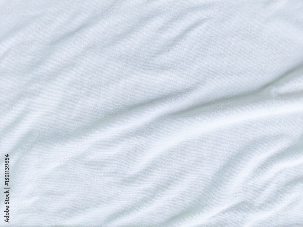 Wrinkled white cloth texture background with wavy cloth surface. Soft and smooth white fabric texture with a clean and minimalist style. Wrinkled white cloth texture background with wavy cloth surface. Soft and smooth white fabric texture with a clean and minimalist style.