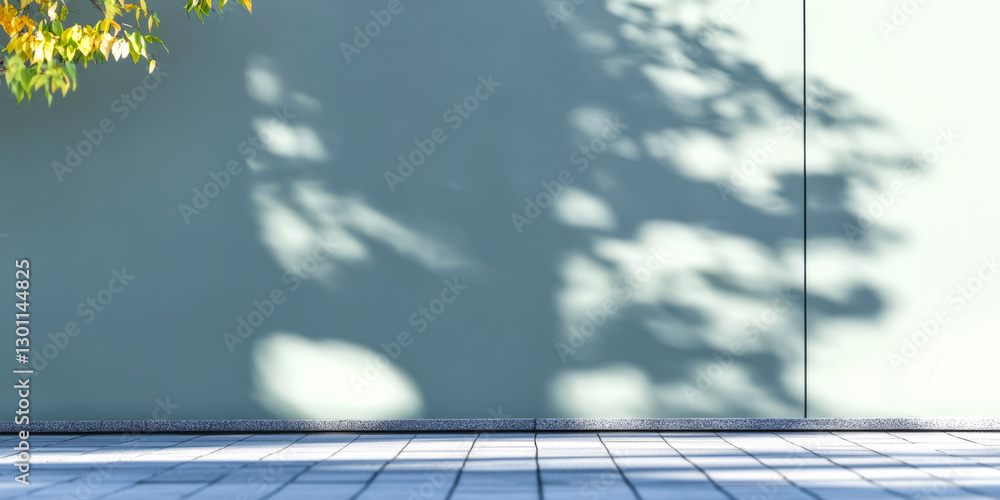 Shadows cast by leaves on a light green wall in a serene outdoor setting Shadows cast by leaves on a light green wall in a serene outdoor setting