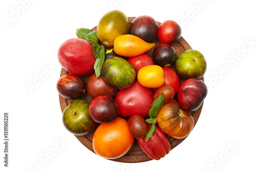 Multicolored tomatoes: red, yellow, orange, green on round wooden board on transparent background. Close-up view of the top