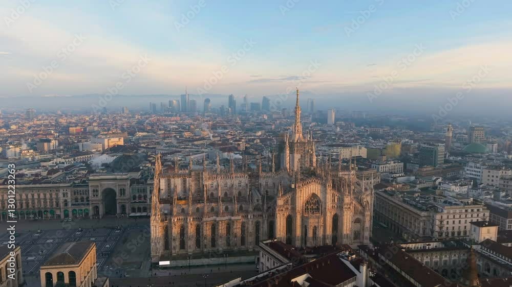 Aerial view of the central spire of the duomo and the city's cathedral at sunset. Milan. Italy Aerial view of the central spire of the duomo and the city's cathedral at sunset. Milan. Italy