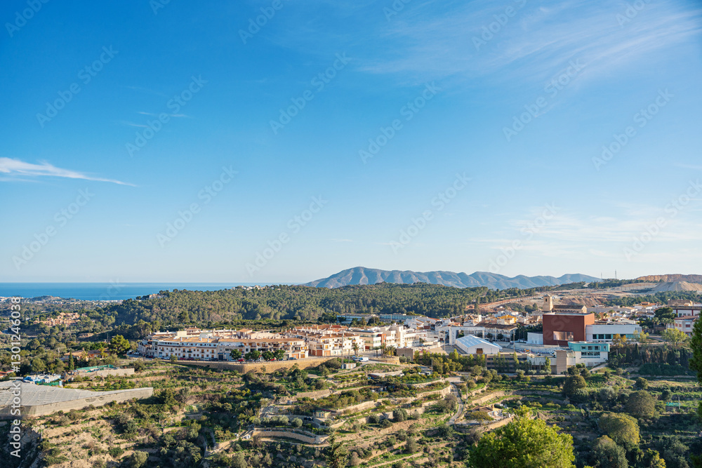 Beautiful view of Polop, Spain with a rocky mountain on the background Beautiful view of Polop, Spain with a rocky mountain on the background