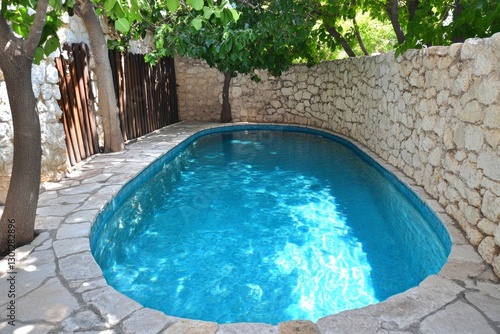 A hidden canyon oasis with a crystal-clear pool surrounded by lush greenery