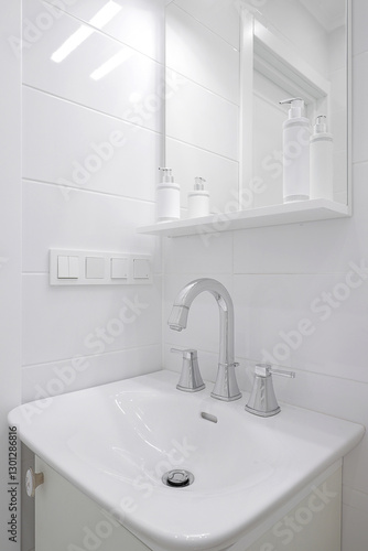 Faucet with ceramic sink and mirror in the bathroom