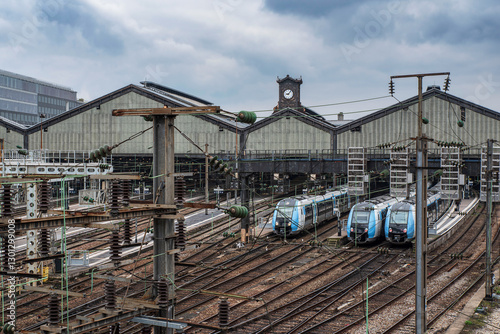 Fototapeta Gare Saint Lazare in Paris, France, with trains parked on the platform rails