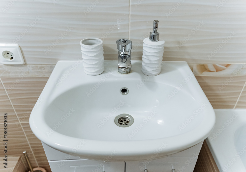 In the bathroom, there is a neatly arranged sink where you can find a toilet brush conveniently placed alongside a soap dispenser, both positioned strategically for easy access during usage In the bathroom, there is a neatly arranged sink where you can find a toilet brush conveniently placed alongside a soap dispenser, both positioned strategically for easy access during usage