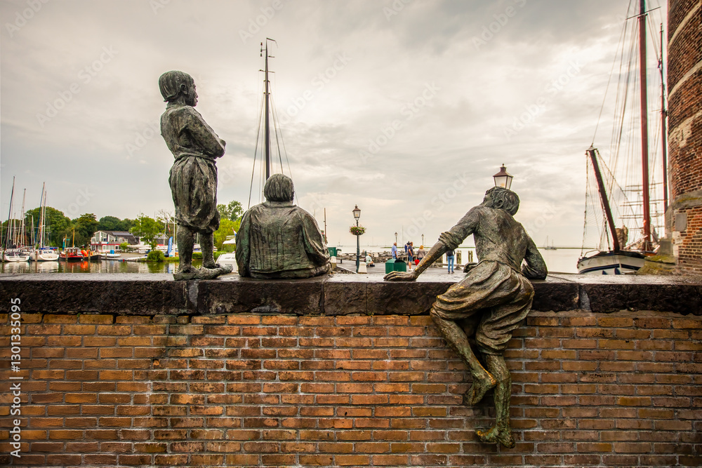 Fototapeta premium De schipjongens van Bontekoe or The cabin boys of Bontekoe is a group of statues on a quay wall at the Hoofd in Hoorn, Netherlands. The statue group was made by sculptor Jan van Druten in 1968