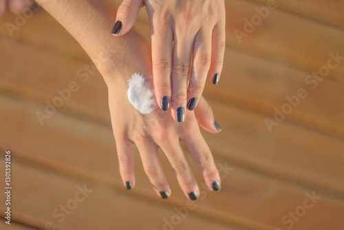 Health skin care, sunscreen, hand cream, putting on sunscreen cream