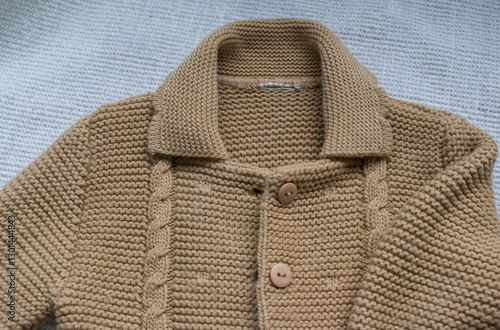 knitted baby sweater on white background