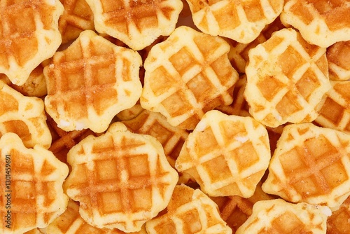 Delicious mini butter waffles with pearl sugar in top view. Waffle background.