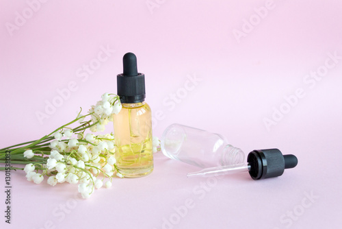 Lily of the valley flower. Dropper glass Bottle makeup. Oil skin care concept