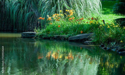 garden vegetation with flowers reflected distorted in still waters of lake water surface