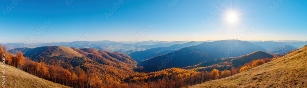 Panoramic view of a mountain landscape with the sun in a blue sky at sunrise Panoramic view of a mountain landscape with the sun in a blue sky at sunrise