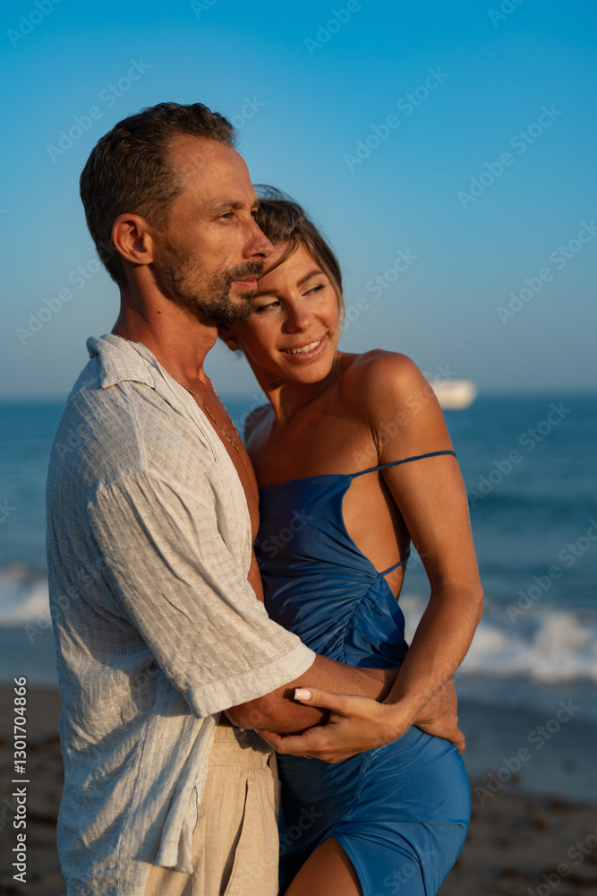 Romantic Couple Holding Hands and Embracing on the Beach.. Romantic Couple Holding Hands and Embracing on the Beach..