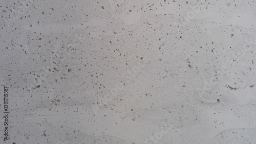 Close-up of a raw concrete wall with a textured surface and imperfections