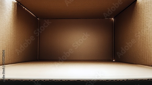 Empty brown cardboard box interior with corrugated texture and warm lighting. photo