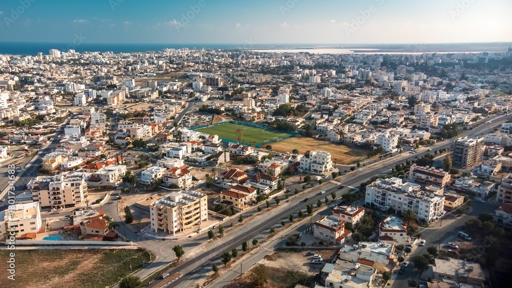 Obraz premium Aerial view of a sprawling urban landscape with residential buildings and roads.