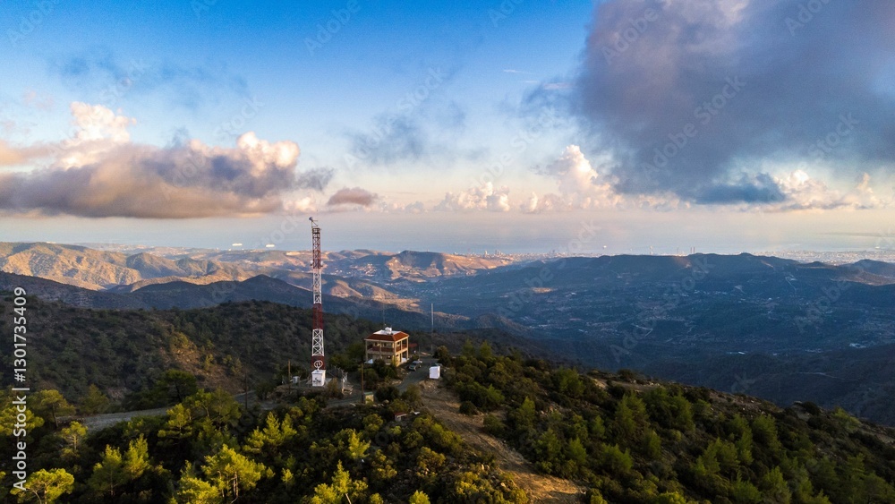 Fototapeta premium Aerial view of a scenic mountainous landscape with a communication tower.
