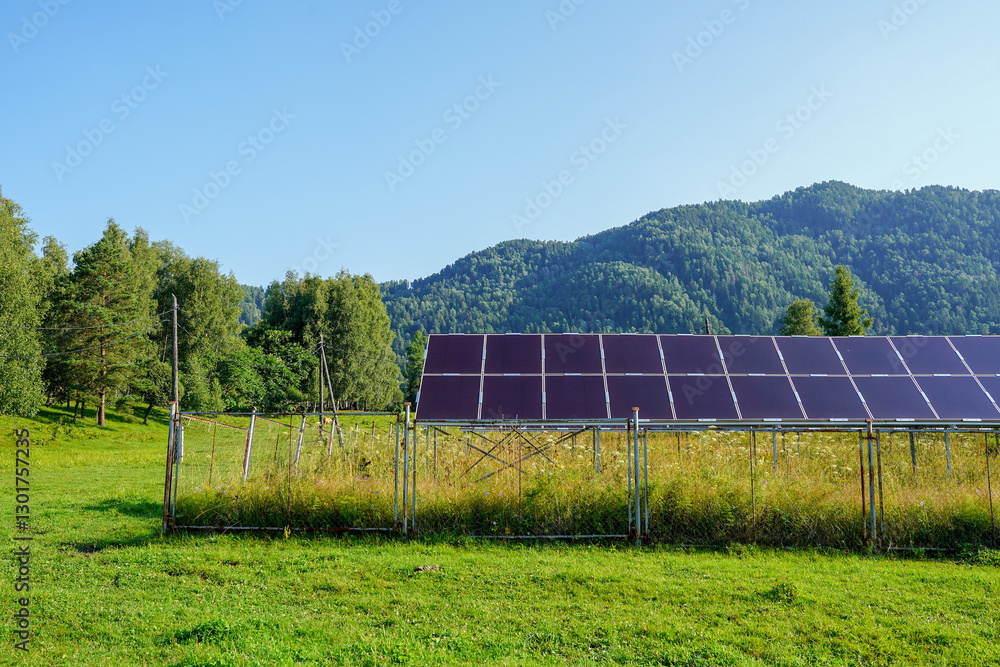Solar panels in a village surrounded by lush forest and mountain views Solar panels in a village surrounded by lush forest and mountain views