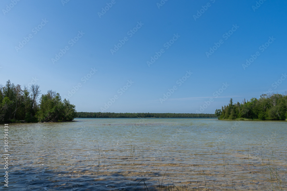 Stunning lake shimmering under the bright summer sun, surrounded by lush greenery and clear blue skies. Stunning lake shimmering under the bright summer sun, surrounded by lush greenery and clear blue skies.