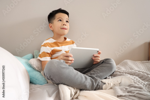 Little Asian boy with table...