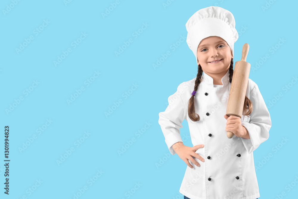 Cute little chef with rolling pin on blue background Cute little chef with rolling pin on blue background