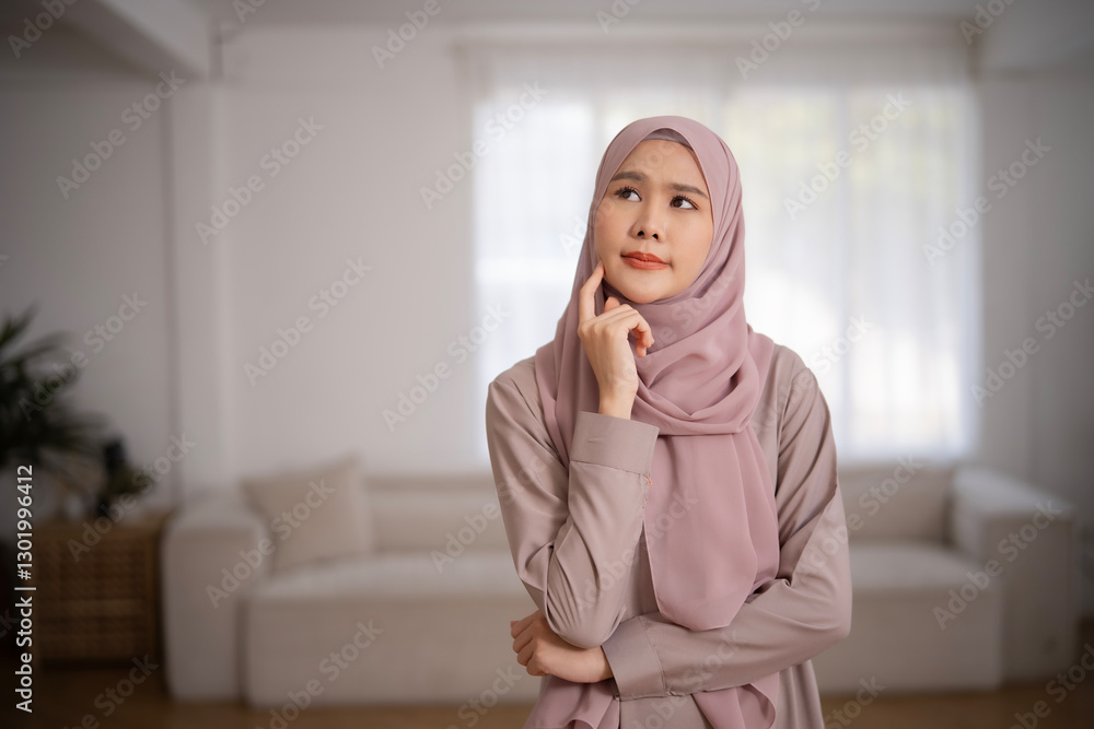 Portrait of Muslim woman wears hijab thinking with smile. Asian Islamic woman in light color religious dress with positive emotion and copy space.