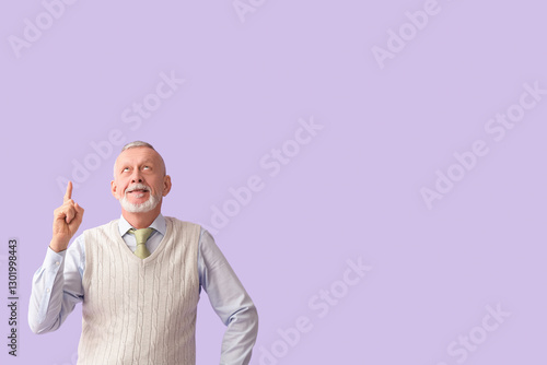 Happy senior man pointing a...
