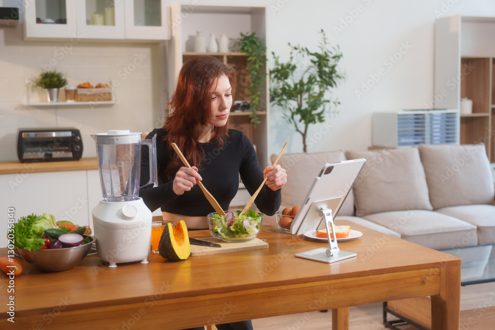 A white woman in workout clothes makes vegetable and fruit juice using a blender on the kitchen table, recommending eating vegetables and fruits online to support healthy, digestion, weight control A white woman in workout clothes makes vegetable and fruit juice using a blender on the kitchen table, recommending eating vegetables and fruits online to support healthy, digestion, weight control