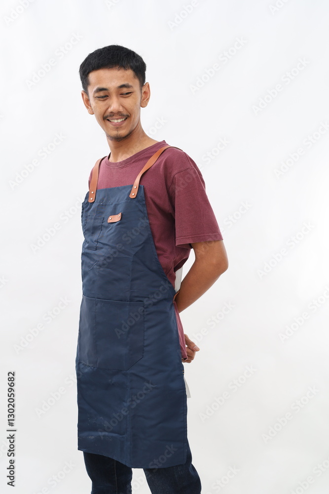 Young asian chef or waiter wearing blue apron isolated on white background Young asian chef or waiter wearing blue apron isolated on white background