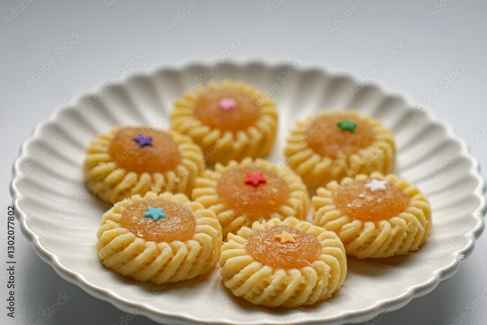 Pineapple Tart or Tart Nenas, a popular cookie in Malaysia during celebration of Eid Mubarak (Hari Raya) isolated on white background with some shadow and selective focus. Pineapple Tart or Tart Nenas, a popular cookie in Malaysia during celebration of Eid Mubarak (Hari Raya) isolated on white background with some shadow and selective focus.