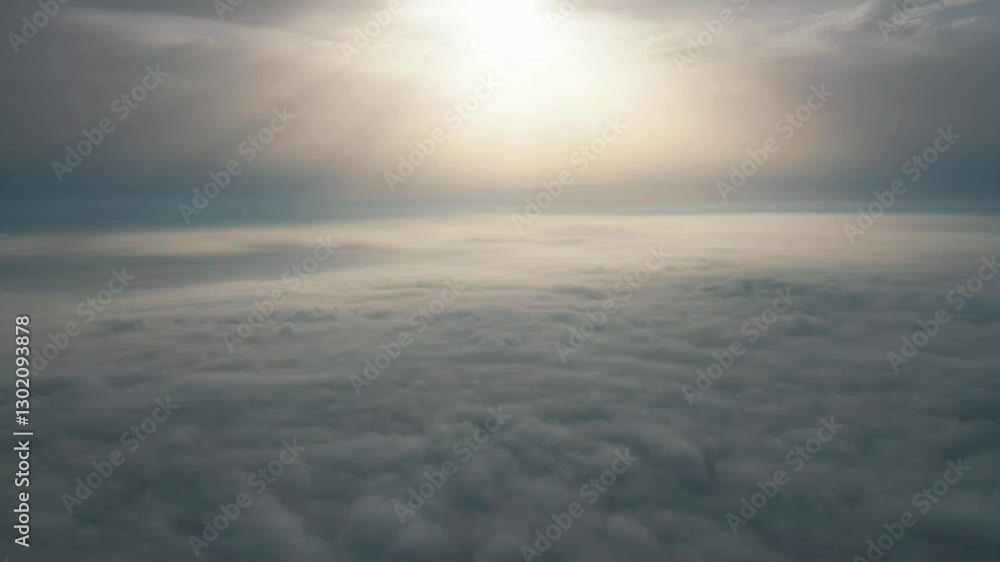 Experience breathtaking aerial views of a dynamic sea of clouds with serene sunlight kisses above the horizon Experience breathtaking aerial views of a dynamic sea of clouds with serene sunlight kisses above the horizon