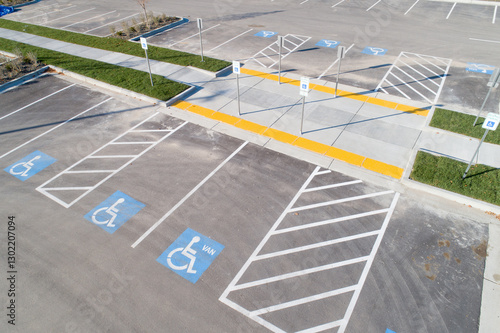 A parking lot with handicap parking spaces and a crosswalk