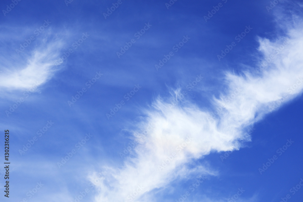 Beautiful white feathery clouds spreading on vivid blue sky Beautiful white feathery clouds spreading on vivid blue sky