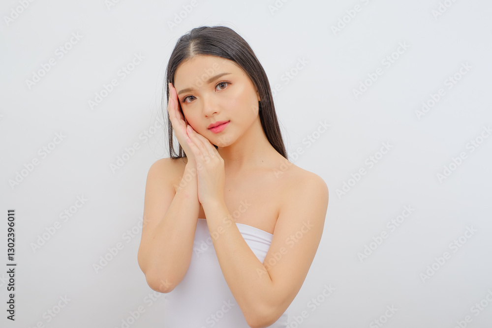 Chic Asian Woman in White Attire Nurturing Her Skin. Great for Beauty Products and Treatments Chic Asian Woman in White Attire Nurturing Her Skin. Great for Beauty Products and Treatments
