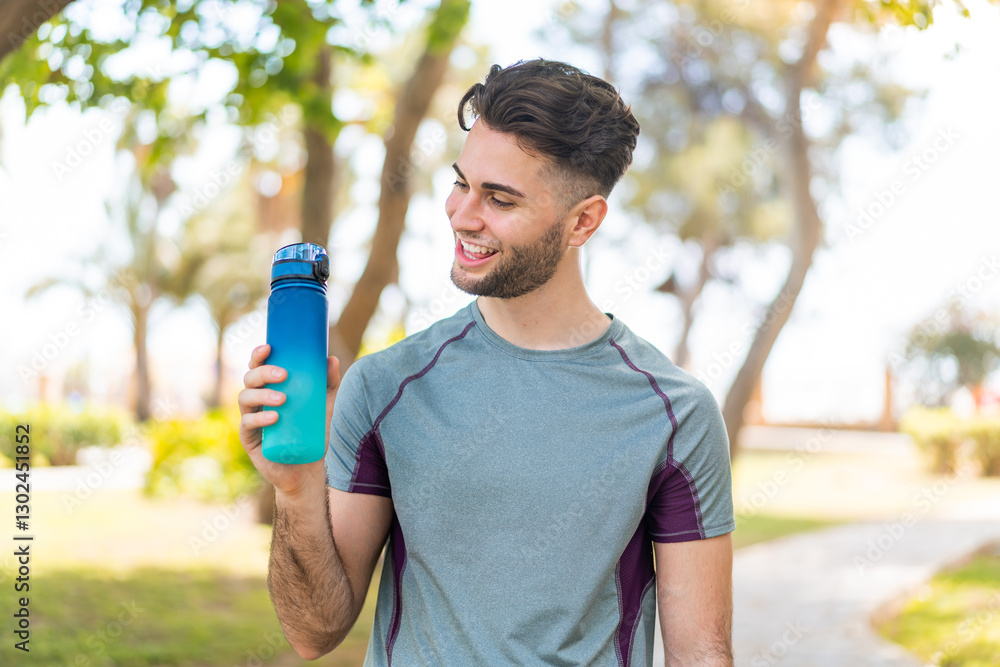 Young handsome sport man with a bottle of water at outdoors with happy expression Young handsome sport man with a bottle of water at outdoors with happy expression