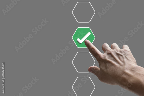 Businessman hand touching to tick correct sign mark on checkbox from checklist  on grey background, Business selection choice concept.