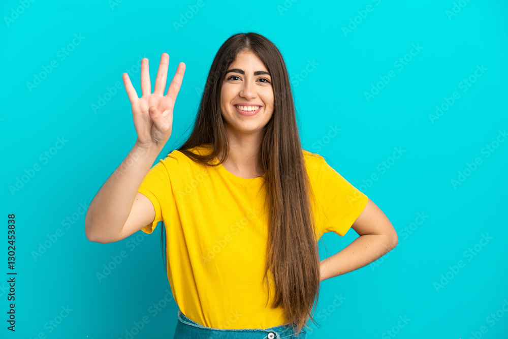 Fototapeta premium Young caucasian woman isolated on blue background happy and counting four with fingers