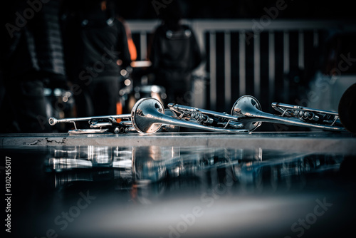 Sticker Shiny brass instruments rest by the fountain, reflecting sunlight in a peaceful outdoor setting
