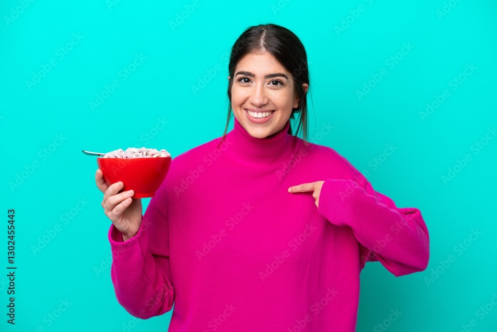 Young caucasian woman holding a bowl of cereals isolated on blue background with surprise facial expression Young caucasian woman holding a bowl of cereals isolated on blue background with surprise facial expression