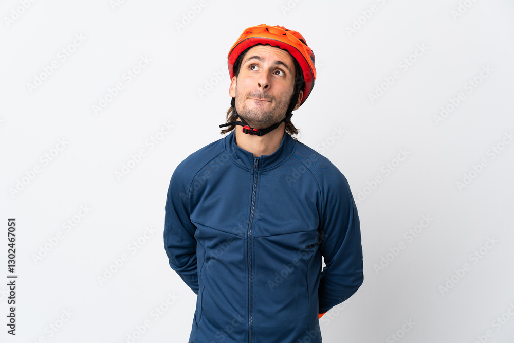 Young cyclist man isolated on white background and looking up Young cyclist man isolated on white background and looking up